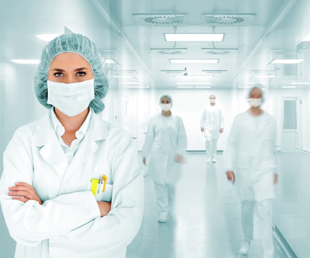 Scientists team at modern hospital lab lead by a woman doctor